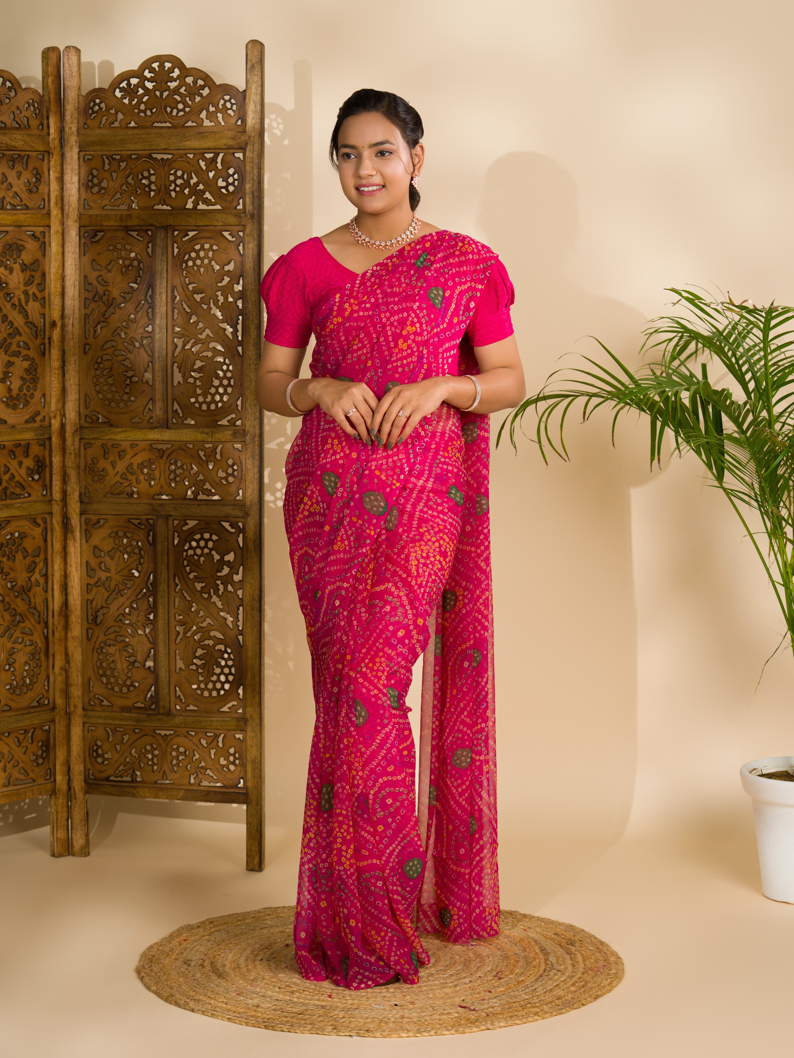 A rani colour geometric patterned saree with bandhani style dots under 500