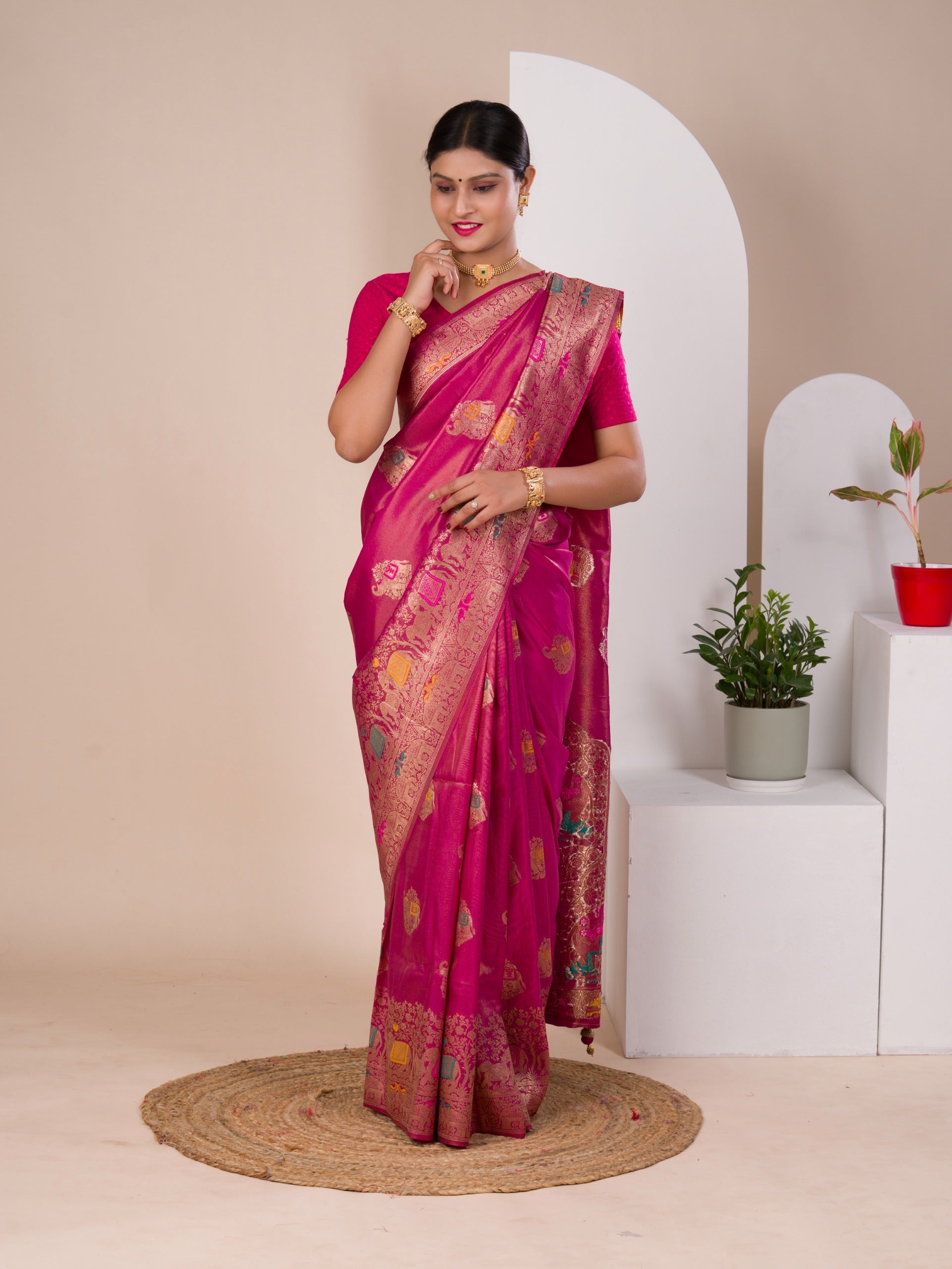 A pink Banarasi style saree with Meenakari weaving, 